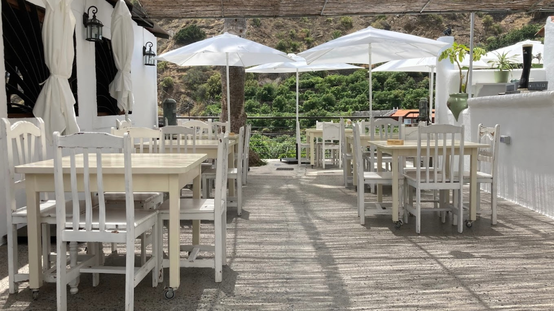 Terasse avec des chaises et tables blanches restaurant Tasca Telémaco à Hermigua à La Gomera