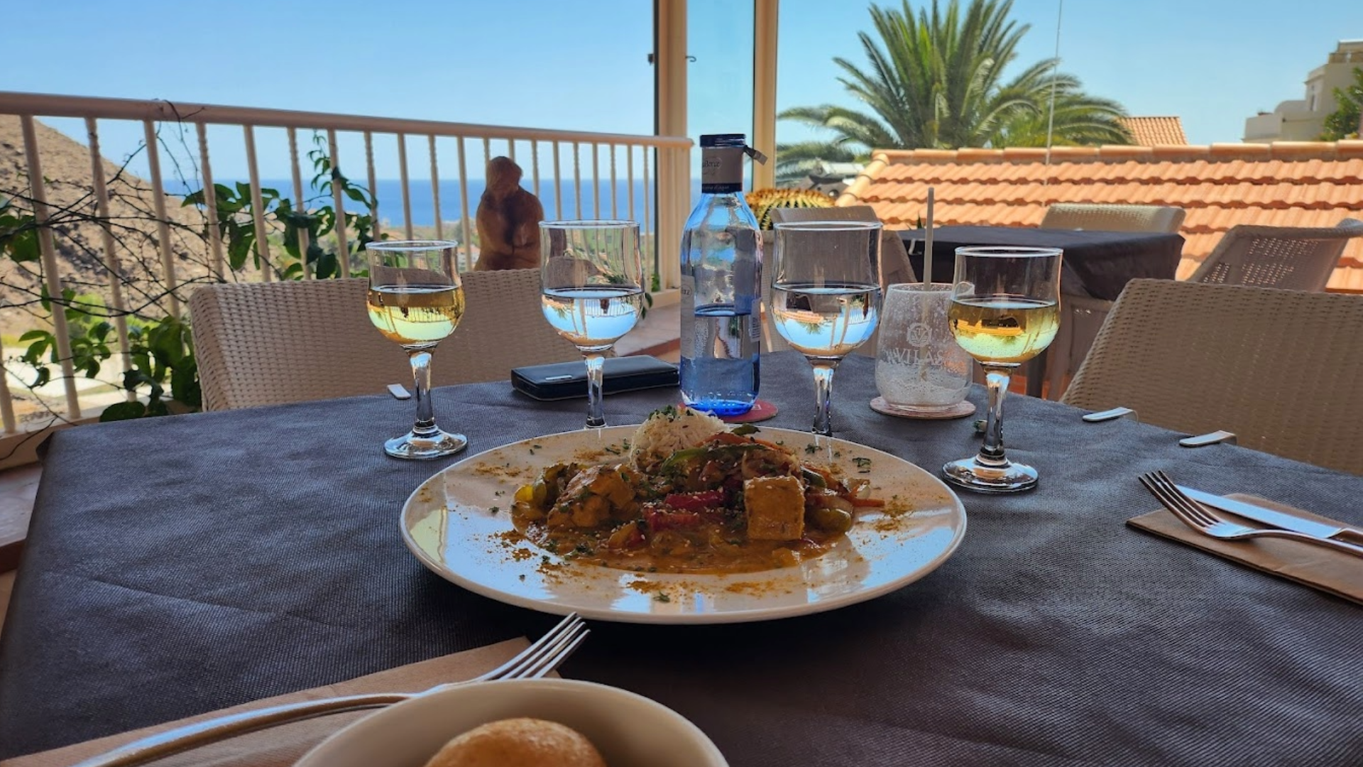 Table avec deux verres d'eau et deux verres de vin et vue sur la mer au restazrant du Mirador de La Gomera